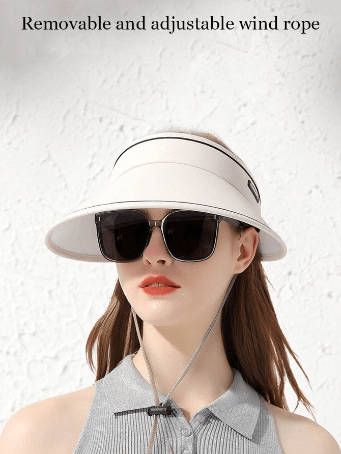Woman wearing adjustable sun proof visor, stylish foldable cap with wind rope for outdoor sun protection.